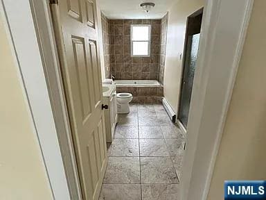 bathroom with a shower with shower door, a tub, baseboards, toilet, and tile patterned flooring