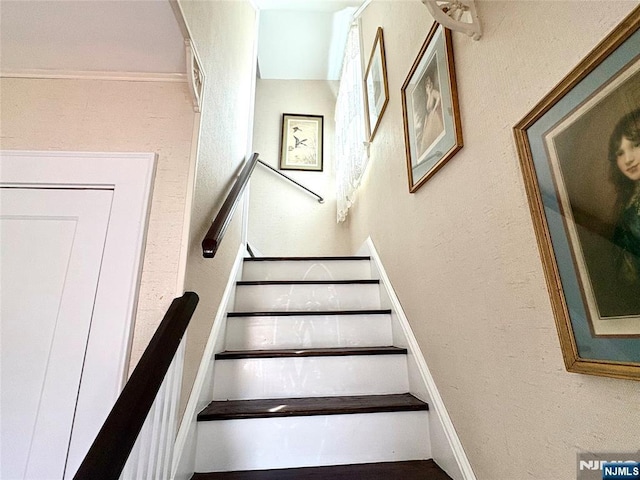 stairs featuring a textured wall