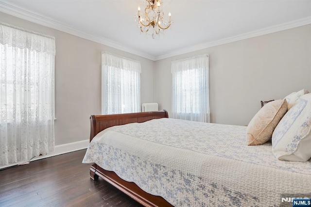 bedroom with crown molding, baseboards, a notable chandelier, and wood finished floors