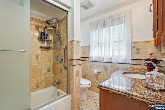 bathroom featuring tile walls, toilet, vanity, and visible vents