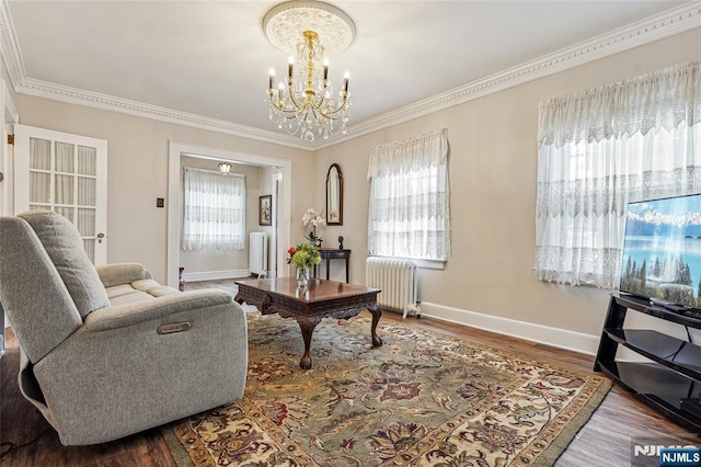 living room with radiator, an inviting chandelier, baseboards, and plenty of natural light