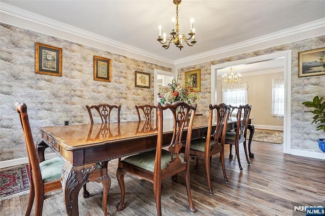 dining area featuring a chandelier, baseboards, crown molding, and wood finished floors