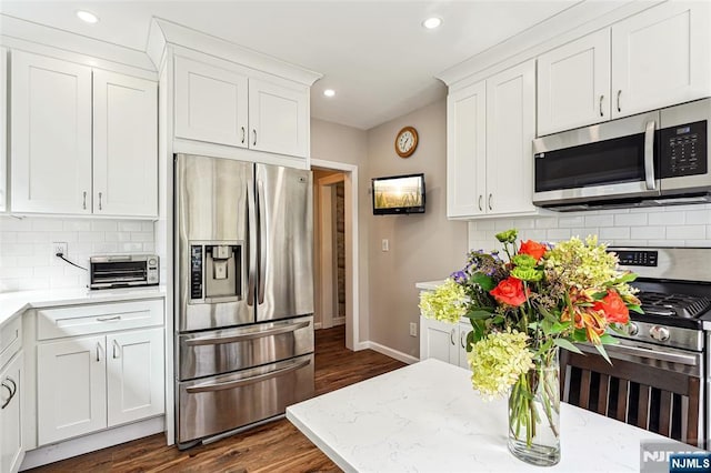 kitchen featuring white cabinetry, appliances with stainless steel finishes, and a toaster