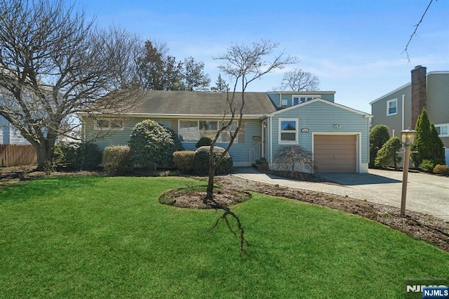 view of front of property with an attached garage, a front lawn, fence, and driveway