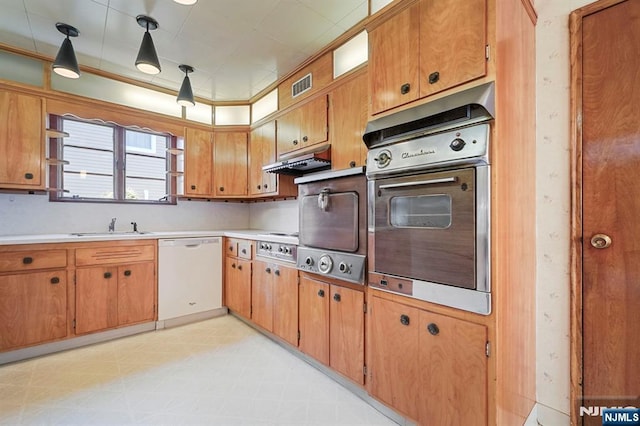 kitchen with visible vents, appliances with stainless steel finishes, light countertops, light floors, and under cabinet range hood
