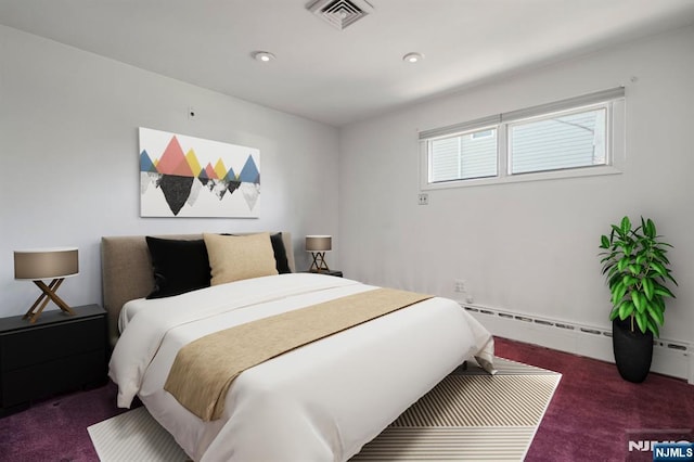 carpeted bedroom featuring a baseboard heating unit, recessed lighting, and visible vents