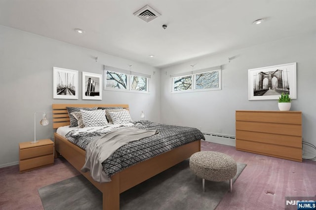 bedroom featuring visible vents and a baseboard radiator
