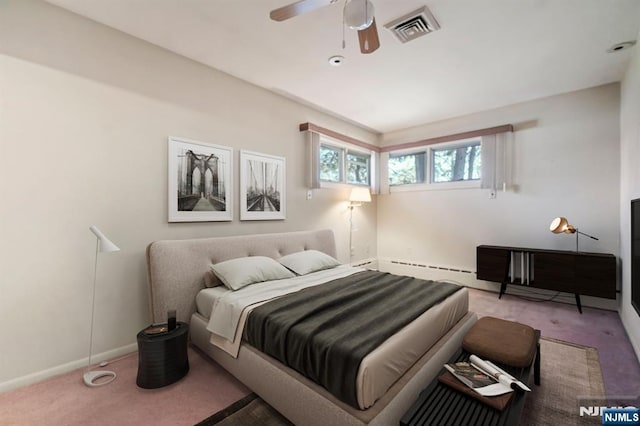bedroom with carpet floors, a baseboard radiator, baseboards, and visible vents