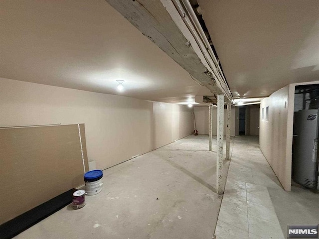 unfinished below grade area featuring water heater