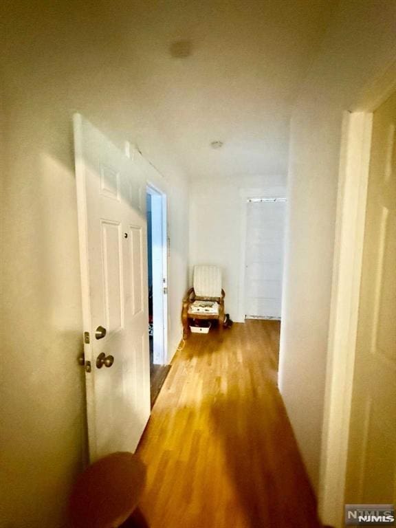 hall with wood finished floors