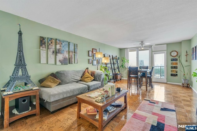 2150 Center Ave Unit 19A, Fort Lee, NJ 07024 - living room with a textured ceiling, ceiling fan, and baseboards