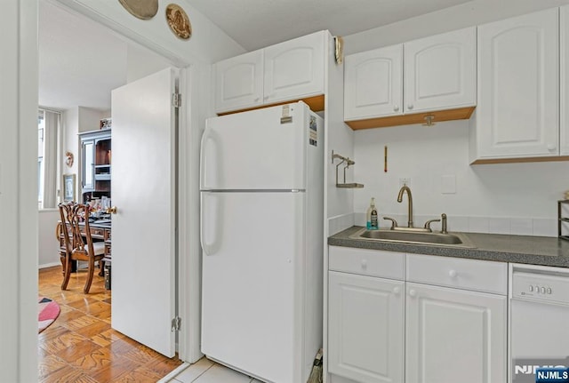 2150 Center Ave Unit 19A, Fort Lee, NJ 07024 - kitchen featuring white appliances, a sink, dark countertops, and white cabinets