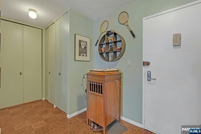2150 Center Ave Unit 19A, Fort Lee, NJ 07024 - hallway featuring a textured ceiling and baseboards