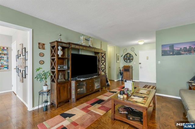 2150 Center Ave Unit 19A, Fort Lee, NJ 07024 - living room featuring baseboards and a textured ceiling