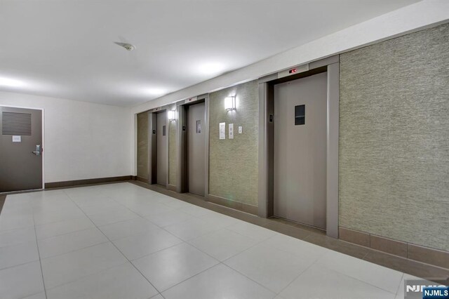 2150 Center Ave Unit 19A, Fort Lee, NJ 07024 - unfurnished room featuring elevator and light tile patterned floors