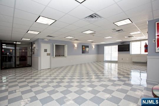 2150 Center Ave Unit 19A, Fort Lee, NJ 07024 - common area featuring wainscoting and a paneled ceiling
