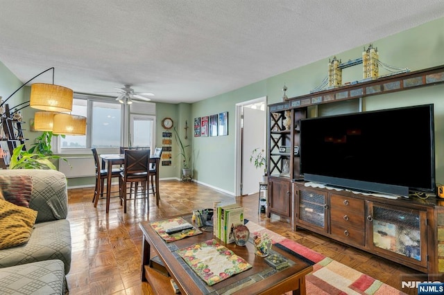 2150 Center Ave Unit 19A, Fort Lee, NJ 07024 - living area featuring a textured ceiling, a ceiling fan, and baseboards