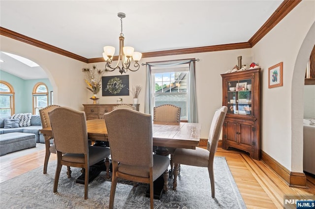 126 Beech St, Nutley, NJ 07110 - dining space with arched walkways, a chandelier, healthy amount of natural light, and ornamental molding