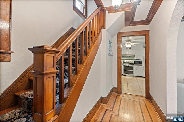 126 Beech St, Nutley, NJ 07110 - staircase featuring ceiling fan, crown molding, a textured wall, baseboards, and wood finished floors