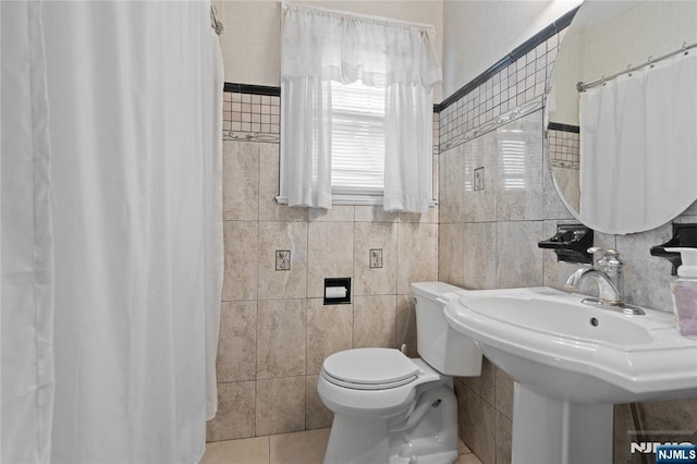 126 Beech St, Nutley, NJ 07110 - bathroom with tile walls, toilet, tile patterned floors, curtained shower, and a sink