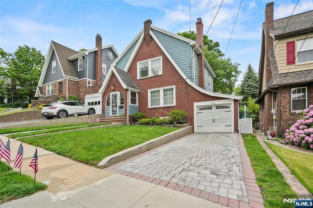 126 Beech St, Nutley, NJ 07110 - tudor-style house with decorative driveway, a front lawn, brick siding, and a garage
