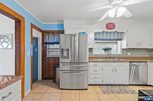 126 Beech St, Nutley, NJ 07110 - kitchen with appliances with stainless steel finishes, a sink, light tile patterned floors, ornamental molding, and white cabinetry