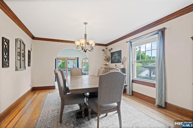 126 Beech St, Nutley, NJ 07110 - dining area featuring healthy amount of natural light, a chandelier, light wood-style flooring, crown molding, and baseboards