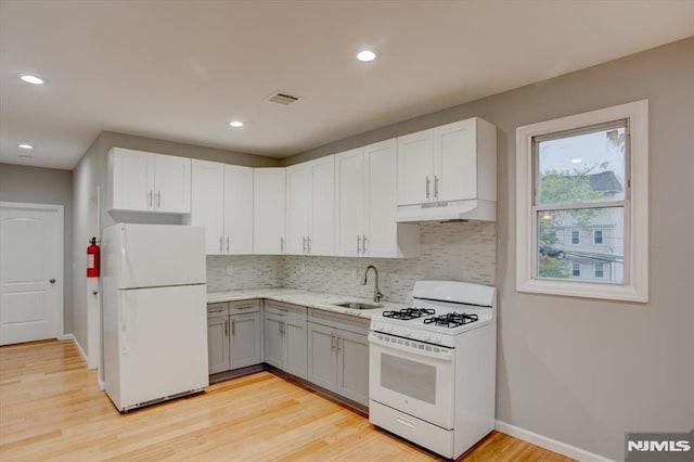 229 21st St, Irvington, NJ 07111 - kitchen featuring white appliances, under cabinet range hood, a sink, decorative backsplash, and gray cabinetry