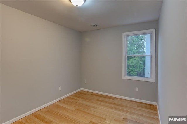 229 21st St, Irvington, NJ 07111 - unfurnished room featuring visible vents, baseboards, and light wood finished floors