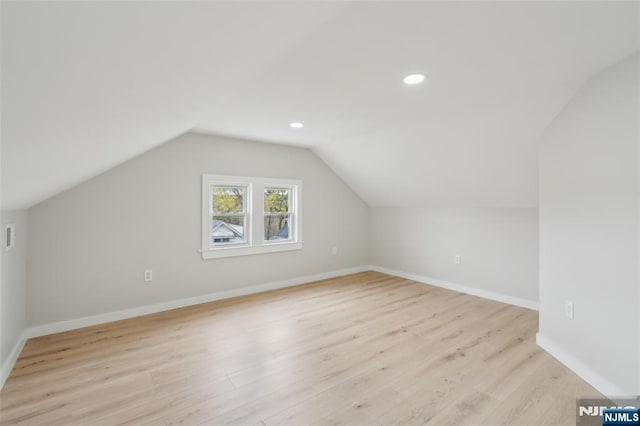 bonus room with recessed lighting, baseboards, lofted ceiling, and light wood-style flooring