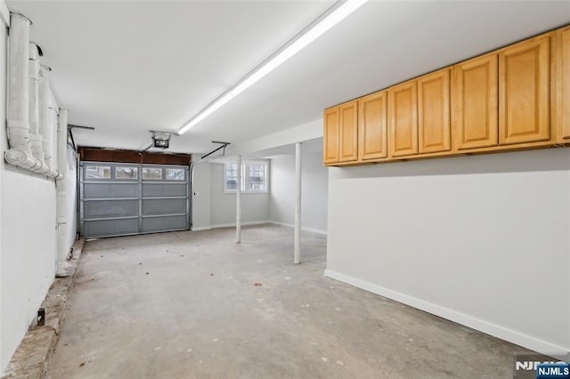 garage featuring baseboards and a garage door opener