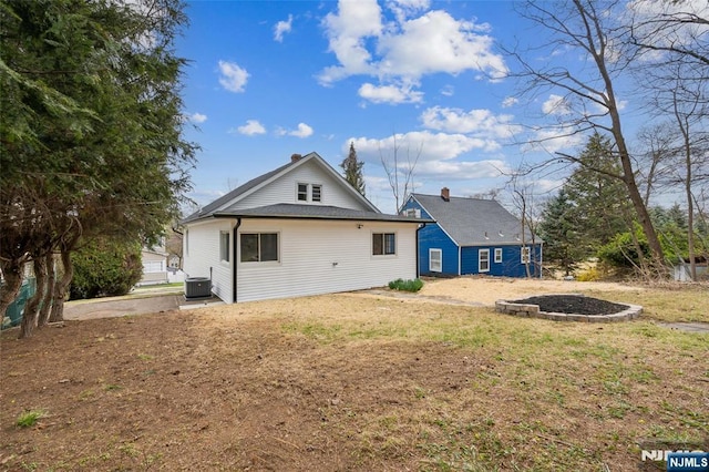 back of house featuring central AC unit