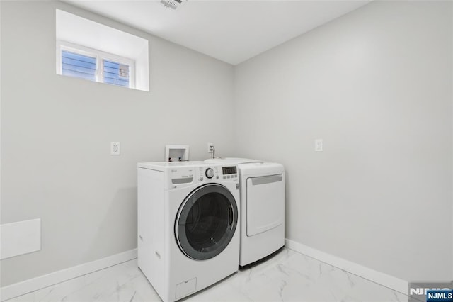 laundry room with baseboards, marble finish floor, separate washer and dryer, and laundry area
