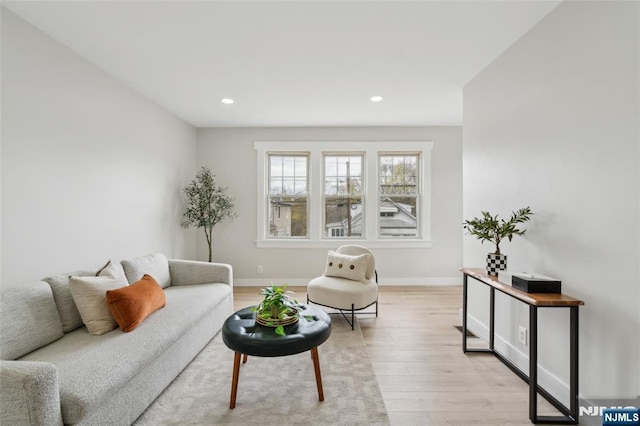 living area featuring baseboards, recessed lighting, and light wood-style flooring