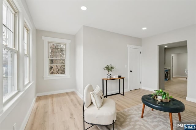 sitting room with recessed lighting, light wood-type flooring, and baseboards
