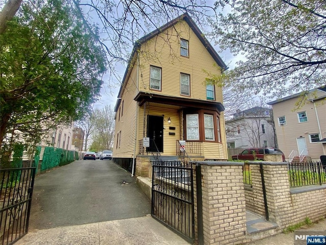 1089 Anna St, Elizabeth, NJ 07201 - view of front facade with a gate and a fenced front yard