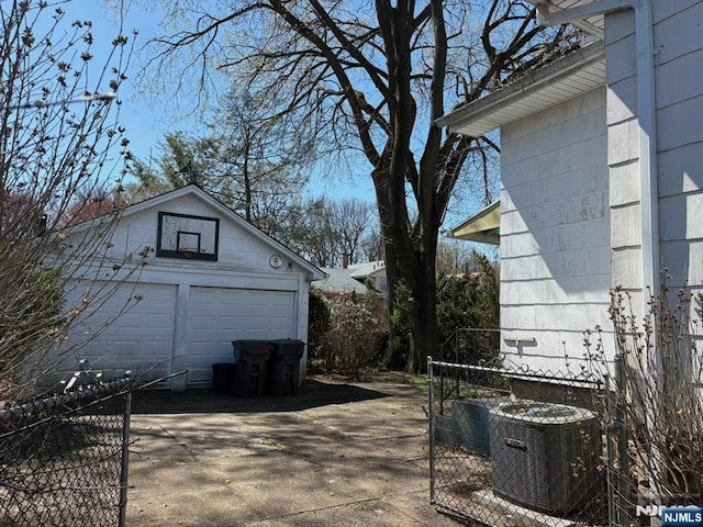 view of home's exterior with an outbuilding, central AC, and a garage