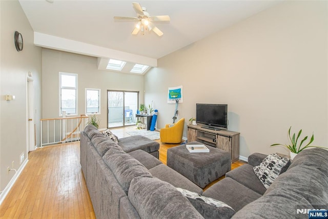 79 Adams Ter Unit 79, Clifton, NJ 07013 - living area with wood-type flooring, baseboards, a ceiling fan, and lofted ceiling with skylight