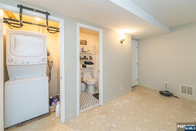 79 Adams Ter Unit 79, Clifton, NJ 07013 - washroom featuring visible vents, light floors, stacked washer / dryer, and laundry area