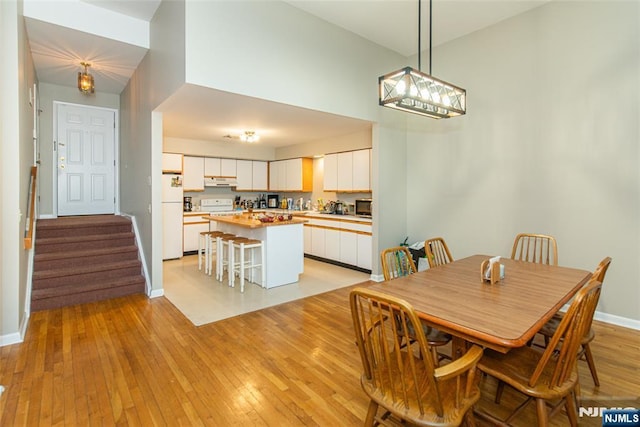 79 Adams Ter Unit 79, Clifton, NJ 07013 - dining space with light wood-type flooring, baseboards, and stairs