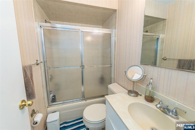 79 Adams Ter Unit 79, Clifton, NJ 07013 - full bath with vanity, toilet, combined bath / shower with glass door, and wallpapered walls