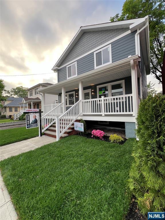 79 Van Winkle Ave, Hawthorne, NJ 07506 - view of front of house featuring covered porch and a front yard