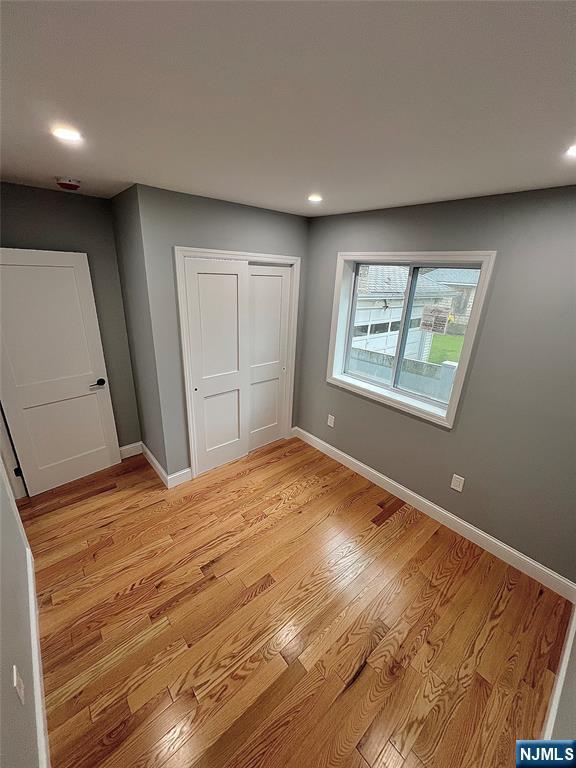 79 Van Winkle Ave, Hawthorne, NJ 07506 - unfurnished bedroom with recessed lighting, light wood-style flooring, baseboards, and a closet