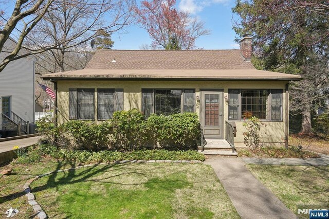 24 Lake Trl, Wayne, NJ 07470 - bungalow-style house featuring roof with shingles, a chimney, and a front lawn