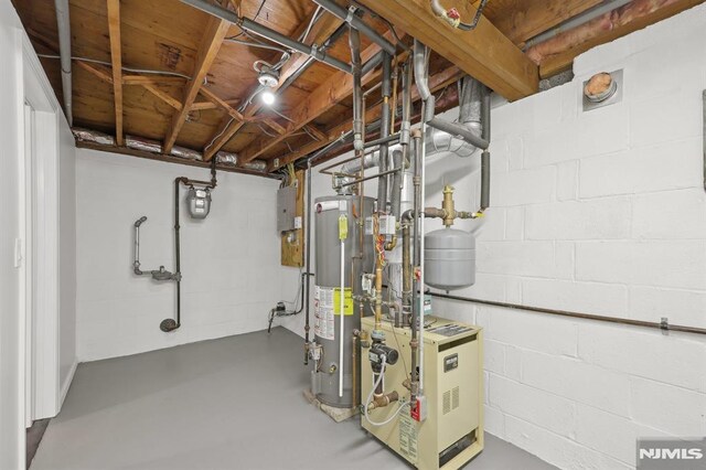 unfinished basement with concrete block wall, a heating unit, and water heater