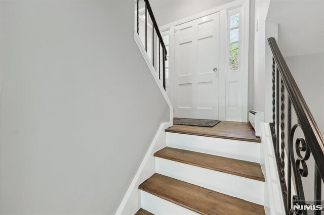 stairway with a baseboard heating unit