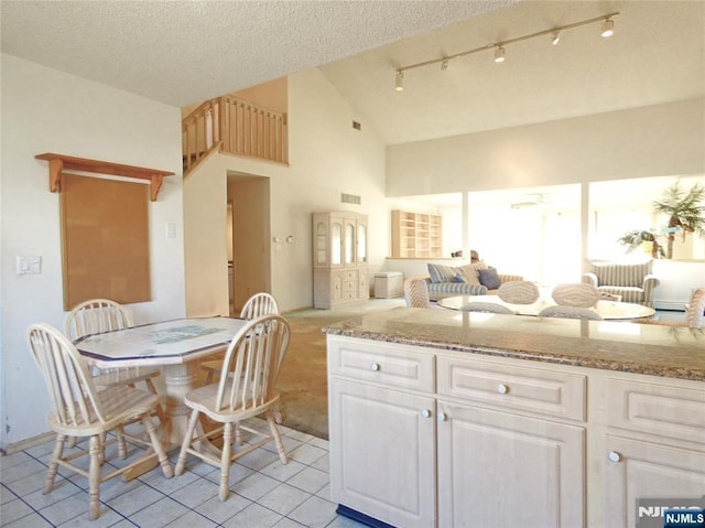 112 Heatherington Ct, Lacey, NJ 08734 - kitchen featuring track lighting, light tile patterned floors, open floor plan, white cabinetry, and light stone countertops