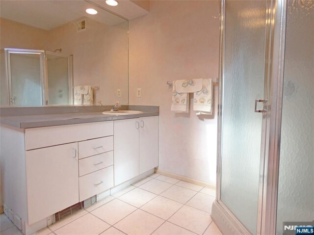 112 Heatherington Ct, Lacey, NJ 08734 - full bathroom with visible vents, baseboards, a shower stall, vanity, and tile patterned flooring