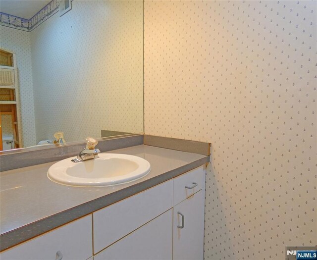 112 Heatherington Ct, Lacey, NJ 08734 - bathroom featuring vanity and wallpapered walls