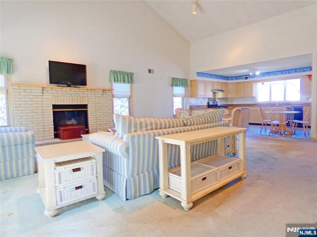 112 Heatherington Ct, Lacey, NJ 08734 - living area with high vaulted ceiling, a brick fireplace, light colored carpet, and visible vents
